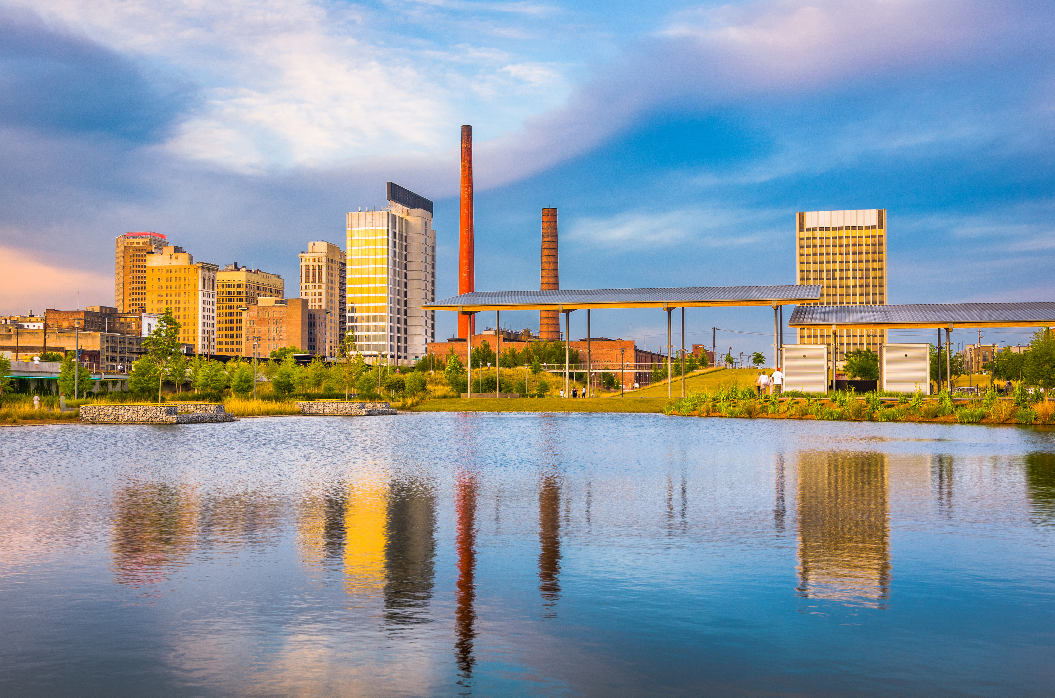 Birmingham skyline and historic smokestacks across Railroad Park